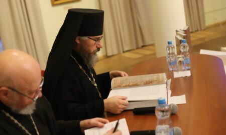 Священник читает Геннадиевскую библию