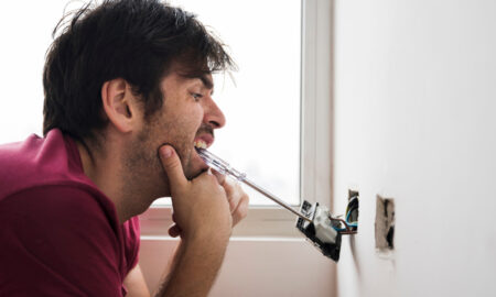 Электрик чинит розетку