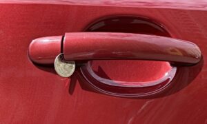 монета в ручке автомобиля