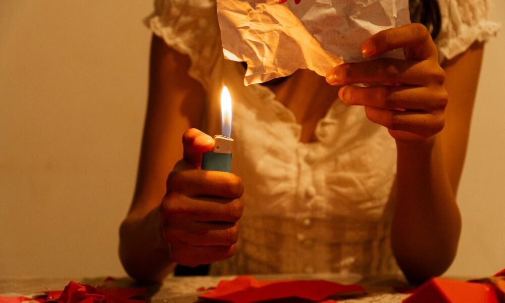 Девушка сжигает листочек