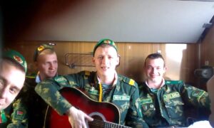 Демобилизованные поют под гитару в поезде